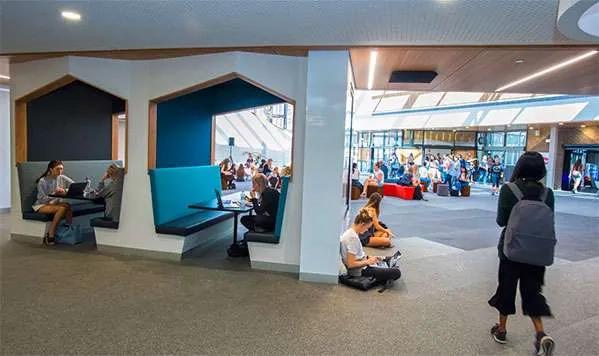 Spacious study area inside Deakin University Burwood campus with students seated and working.